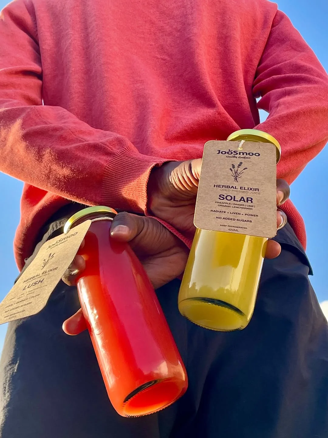 JooSmoo juices held in the sunshine